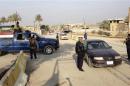 Iraqi security forces check vehicles as they take part in an intensive security deployment in Ramadi, 100 km (62 miles) west of Baghdad