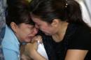 Family members of passengers onboard missing AirAsia flight QZ8501 cry at a waiting area in Juanda International Airport, Surabaya