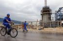 A picture taken on January 27, 2011 shows an Iranian worker riding a bicycle through the Nouri Petrochemical facilities of the South Pars gas field in the southern port of Assaluyeh