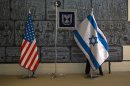 Employee arranges an Israeli national flag at the residence of Israel's President in Jerusalem, ahead of U.S. President Obama's visit
