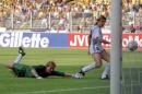 FILE - In this June 24, 1990 file photo, Argentina's Claudio Caniggia, right, scores, as the Brazilian goalkeeper Claudio Taffarel watches helplessly, during the World Cup second round soccer match, in Turin, Italy. On this day: Against the run of play, Argentina beats rival Brazil 1-0 to progress to the quarterfinals. (AP Photo/Luca Bruno, File)