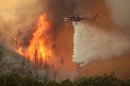 Helicopters battle the 64,000 acre Beaver Creek Fire on Friday, Aug., 16, 2013 north of Hailey, Idaho. A number of residential neighborhoods have been evacuated because of the blaze.(AP Photo/Times-News, Ashley Smith) MANDATORY CREDIT