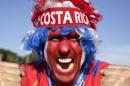 A supporter celebrates Costa Rica's classification at the end of the World Cup group D match against England, at the Mineirao Stadium, in Belo Horizonte, Brazil, Tuesday, June 24, 2014. Costa Rica finished first in what many considered the World Cup's toughest group after a dour 0-0 draw against England. (AP Photo/Bruno Magalhaes)
