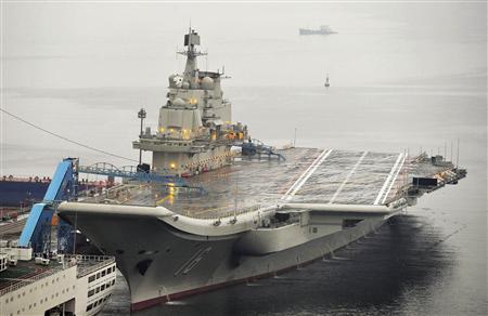 China's first aircraft carrier, which was renovated from an old aircraft carrier that China bought from Ukraine in 1998, is seen docked at Dalian Port, in Dalian, Liaoning province in this September 22, 2012 file photo. China's first aircraft carrier, the Liaoning, officially entered naval ranks on September 25, 2012 the country's Ministry of Defence announced, in a move that it said would help project maritime power and defend Chinese territory. REUTERS/Stringer/Files