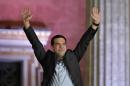 Syriza leader Alexis Tsipras greets supporters following victory in the election in Athens on January 25, 2015