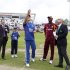 England captain Alastair Cook throws the coin atn the toss watched by West Indies captain Darren Sammy