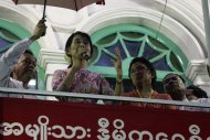 Myanmar Opposition leader Aung San Suu Kyi, centre, talks to supporters during an opening ceremony of a branch office of her National League for Democracy (NLD) party on Monday, May 7, 2012, in Yangon, Myanmar. (AP Photo/Khin Maung Win)