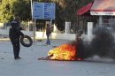 A protester burns tyres during clashes with police in Siliana