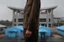 In this photo taken Monday, July 22, 2013, North Korean soldiers stand guarding the truce village of Panmunjom at the Demilitarized Zone (DMZ) which separates the two Koreas in Panmunjom, North Korea. Some Americans call it the 