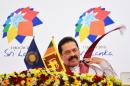 Sri Lanka President Mahinda Rajapaksa listens during a press conference during the Commonwealth Heads of Government Meeting in Colombo on November 16, 2013