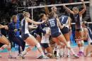 United States' players celebrate after defeating Brazil during a semifinal volleyball match, at the women's Volleyball World Championships in Milan, Italy, Saturday, Oct. 11, 2014. (AP Photo/Felice Calabro')