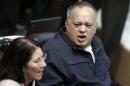 Deputy of Venezuela's PSUV Cabello talks to his fellow deputy Flores during a session of the National Assembly in Caracas