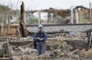 An investigators looks over a destroyed fertilizer plant in West, Texas, Thursday, May 2, 2013. Investigators face a slew of challenges in figuring out what caused the explosion at the fertilizer plant that killed 14 people and destroyed part of the small Texas town. (AP Photo/Pool/ LM Otero, Pool)