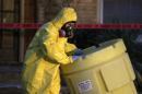 A hazmat worker outside an apartment building in Dallas