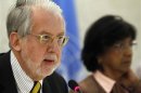 Chair of the Commission of Inquiry on Syria Paulo Pinheiro delivers his report next to UN human rights chief Pillay during the Human Rights Council at the United Nations in Geneva
