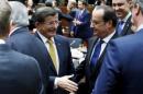 Turkish PM Davutoglu and France's President Hollande attend a EU leaders summit in Brussels