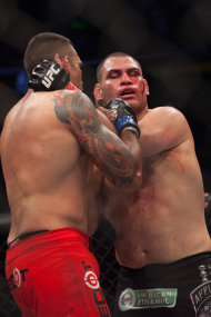 Cain Velasquez (R) and Fabricio Werdum grapple during their heavyweight title unification bout. (Getty)
