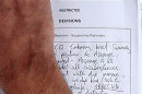 A document is held by an unidentified British police officer, which outlines that 