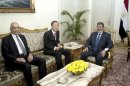 Egypt's President Mohamed Mursi, Egypt's Foreign Minister Mohamed Kamel Amr and U.N. Secretary-General Ban Ki-moon meet at the presidential palace in Cairo
