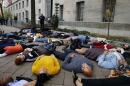 Protestors stage a "die-in" as they rally against the Ferguson, Mo. Grand Jury exoneration of police officer Darren Wilson, at the U.S. Justice Department in Washington