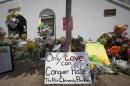 A sign is pictured at a makeshift memorial for victims of a mass shooting, outside the Emanuel African Methodist Episcopal Church in Charleston