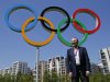 IOC President Jacques Rogge poses in front of the Olympic rings during his visit to the Athletes' Village at the Olympic Park, Monday, July 23, 2012, in London. (AP Photo/Jae C. Hong)