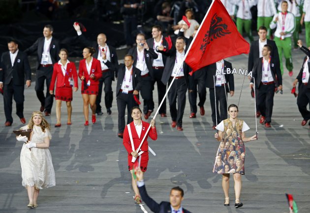 Albania's flag bearer Romela Begaj holds the national flag as he leads the contingent in the athletes parade during the opening ceremony of the London 2012 Olympic Games