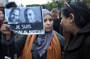 A Tunisian demonstrator holds a placard with the photo of Tunisian journalists Sofiene Chourabi and Nadhir Ktari which reads in French "I am Sofiene and Nadhir" during a demonstration in Tunis on January 9, 2015