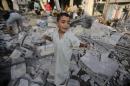 Palestinian boy cries as he stands in a debris-strewn street near his family's house in Rafah in the southern Gaza Strip
