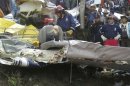Rescuers workers inspect the wreckage of a Cessna in a wooded area in western Guatemala
