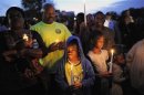 A boy wears hooded sweatshirt, as he joins a candlelight vigil at exact moment when Martin was shot a year ago in Sanford