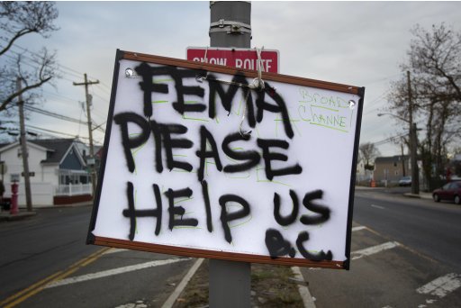 A sign asking for help from FEMA (Federal Emergency Management Agency) is seen in the BroadChannel section of the Queens borough of New York