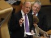 Scotland's Finance Secretary Swinney gestures during his draft budget address in debating chamber of Scottish Parliament in Edinburgh