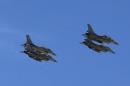Planes belonging to the Jordanian Royal Air Force fly over the headquarters of the family clan of pilot Kasaesbeh in Karak