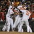 Baltimore Orioles Chris Davis, center, is picked up by teammates after driving in the game winning run against the Boston Red Sox in the 13th inning of a baseball game Thursday, June 13, 2013 in Baltimore. (AP Photo/Gail Burton)
