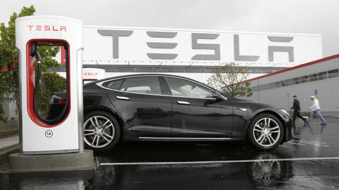 Tesla's loss triples in 2Q as it lowers delivery forecast