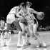 FILE - Los Angeles Lakers' Jerry West (14) is fouled as he tries to get around Houston Rockets' John Vallely after teammate Wilt Chamberlain set screen in game at the Forum in Inglewood, Calif., in this Dec. 27, 1971 file photo.  The Lakers went on to their 28th straight win, beating the Rockets 137-115.  (AP Photo, File)
