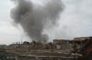 Smoke rises above a building during an air strike in Ramadi city
