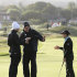 Suzann Pettersen, left, and Christie Kerr, right,  talk to a rules official about the suspension of play during day two of the Women's British Open at the Royal Liverpool Golf Course, in Hoylake, England, Friday Sept. 14, 2012.  Play was suspended after about an hour of play because of strong winds that disrupted the second round so badly that organizers declared early scores "null and void."  With winds gusting to 60 mph, all the players struggled and American Cristie Kerr had her ball blown off the 12th tee three times. (AP Photo / Peter Byrne, PA) UNITED KINGDOM OUT - NO SALES - NO ARCHIVES