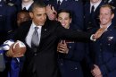 FILE- In this April 23, 2012 file photo, President Obama strikes the Heisman pose after he awarded the Commander-in-Chief Trophy to the Air Force Academy football team at the White House in Washington. 