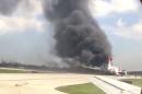 A still image from a handout video footage by Mike Dupuy shows Dynamic International Airways' Boeing 767's engine on fire in Fort Lauderdale Florida