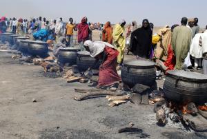 Women cook in pots heated with firewood at an Internally&nbsp;&hellip;