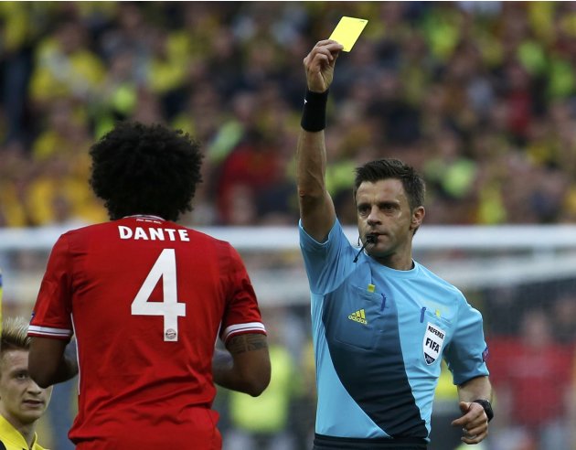 Referee Rizzoli of Italy shows a yellow card to Bayern Munich's Dante during their Champions League Final soccer match against Borussia Dortmund at Wembley Stadium in London