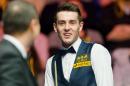 England's Mark Selby jokes with the referee at Alexandra Palace in north London on January 20, 2013