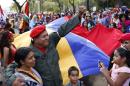 Man dressed as late Venezuelan President Hugo Chavez waves during the Carnival festival in Caracas