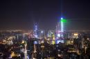 Light and laser illuminate the Lujiazui financial district of Pudong in Shanghai during a light show as part of a New Year countdown celebration on the Bund in Shanghai