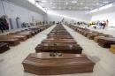 The coffins of 111 died migrants are lined up inside an hangar of Lampedusa's airport, Italy, Saturday, Oct. 5, 2013. A ship carrying African migrants towards Italy capsized Thursday off the Sicilian island of Lampedusa after the migrants on board started a fire to attract attention. Just 155 people survived, 111 bodies have been recovered and more than 200 are still missing. The tragedy has prompted outpourings of grief and calls for a comprehensive EU immigration policy to deal with the tens of thousands fleeing poverty and strife in Africa and the Middle East. (AP Photo/Luca Bruno)