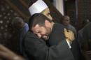 The Imam of al Thawrah Mosque, Samir Abdel Bary, gives condolences to Tarek Abu Laban, center, who lost four relatives, all victims of Thursday's EgyptAir plane crash, following prayers for the dead, at al Thawrah Mosque, in Cairo, Egypt, Friday, May 20, 2016. The Airbus A320 plane was flying from Paris to Cairo with 66 passengers and crew when it disappeared early Thursday over the Mediterranean Sea. (AP Photo/Amr Nabil)