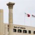 Flags fly over a Bank of Valletta branch near the ruins of the Royal Opera House in Valletta