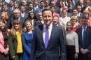 British Prime Minister David Cameron (C) poses for a group photo with newly-elected Conservative MPs at the Houses of Parliament in central London on May 11, 2015